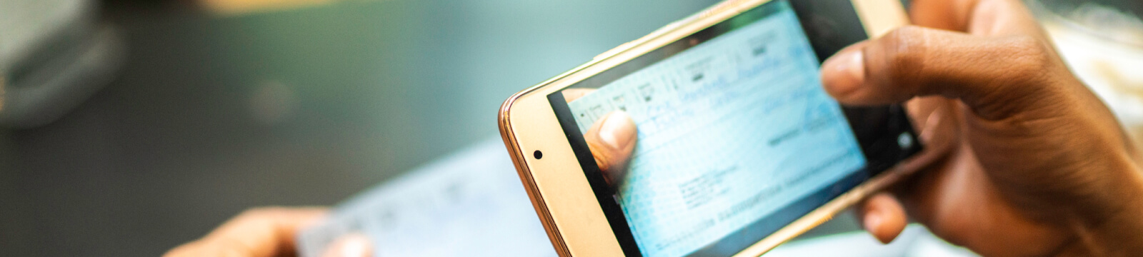 Person using mobile phone to deposit a check